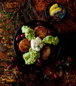A bowl with veggie fritters, kidney beans, guacamole and cream cheese