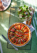 Vegetable tart and a green salad with young horseradish leaves and Parmesan cheese