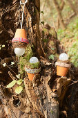 Lantern lampshades hand-made from terracotta pots decorated with fabric trim