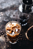 A glass of iced coffee with a spoon