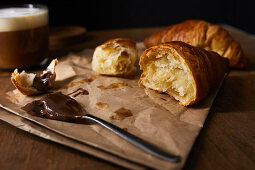 Fresh croissant with hazelnut spread and coffee for breakfast