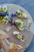 White bread and floral butter decorated with wild summer flowers