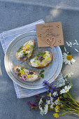 White bread with edible flowers and posy of wildflowers