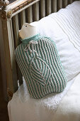 Hand-knitted mint-green cover for hot water bottle