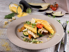 Polenta slices with gremolata, aubergine, zucchini, cress and Parmesan
