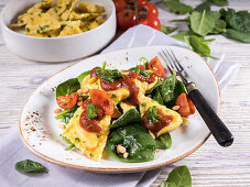 Stuffed tortellini on sauteed spinach with tomato ragout