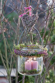 Hanging glass lantern with wreath and heart made of bud blooming heather