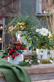 Christmas decorated arrangement with Christmas rose, Gaultheria, sedge, Coral bells and pohuehue