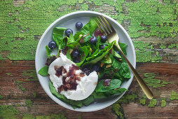 Spinach salad with blueberry dressing and burrata