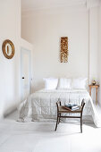 Light-flooded bedroom with stucco ceiling