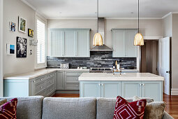 Open-plan country-house kitchen with pale blue cupboards