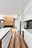 Moderne offene Küche in Weiß im Wohnraum mit Holzboden