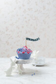 A cupcake with raspberry cream, forget-me-nots and rabbits (Easter)