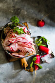 Sliced radishes in ceramic bowls