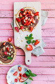 Strawberry pancakes with chocolate cream and almond flakes