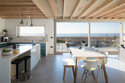 Modern, open-plan interior with sea view