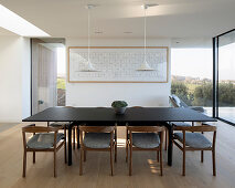 Dark table and armchairs in minimalist dining area