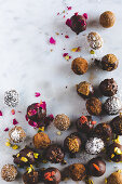 Various chocolate truffles on a marble surface