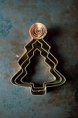 Three Christmas tree cookie cutters nesting one inside the other