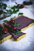 Berry and cherry tart with mint, sliced