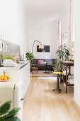 Kitchen counter, desk and seating area in narrow interior