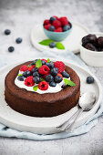 Brownie cake without flour and sugar served with Greek yogurt and berry fruits