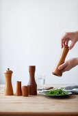 Hands holding spice grinder
