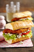 Baguettes with chicken schnitzel, salad, remoulade sauce and tomato