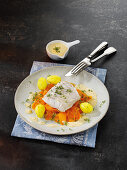 Poached cod on a bed of vegetables