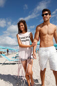 A young couple walking on a beach