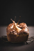 Vegan chocolate cake with baked pears, glazed with elderflower jelly