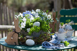 Pot with parsley and horned violets Easter with Easter bunny, Easter eggs, and wreath of branches