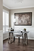 Desk with marble top, upholstered chair and standard lamp in study