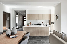 Dining area, sofa and kitchen in open-plan interior