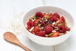 Porridge with red berries and pomegranate seeds