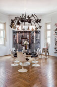 Chandelier of angle-poise lamps above designer table in period interior