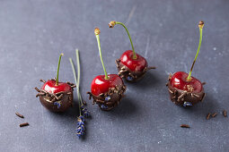 Cherries with chocolate, chocolate sprinkles, lavender flowers and gold powder