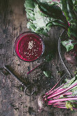 Rote-Bete-Smoothie mit Sesam auf Holztisch