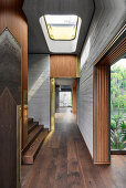 Hallway with skylight and wooden stairs