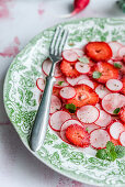 Salad with radish, strawberries, mint and pepper