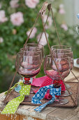 Wine glasses labelled with strips of various fabrics on tray