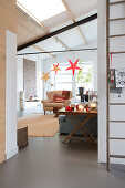 Stars hung from beam in festively decorated living room