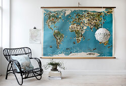 Black rattan chair in front of a vintage style map of the world