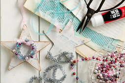 Handmade nostalgic star ornaments made out of paper, ribbons, and beads