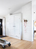 White built-in cupboard in under a pitched roof