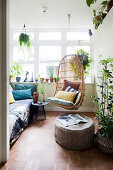 Hanging chair and footstool in the winter garden