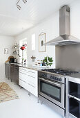 A kitchenette with a gas cooker and an extractor fan