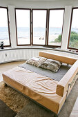 Light brown leather sofa in the living room with a curved wall