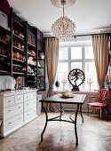 Wall shelf, chest of drawers, table, and chair in a walk-in cloakroom