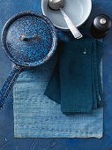 Blue saucepan, bowl, cutlery and cloth napkins